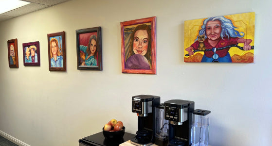 Custom commissioned portraits by Meg Harper displayed together on a client's office wall
